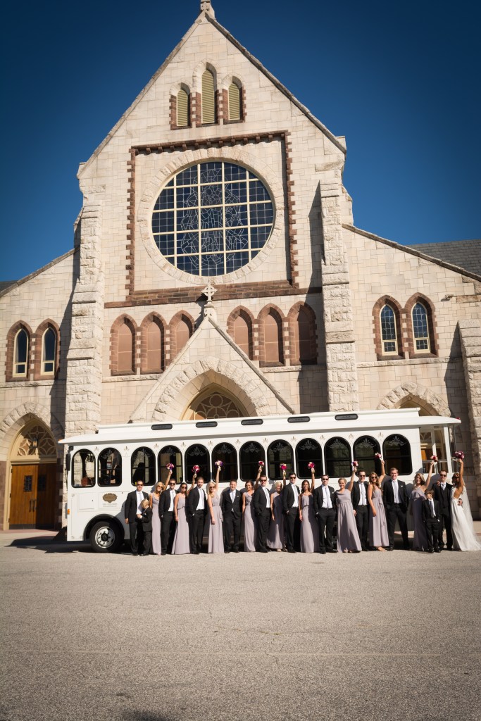 wedding party in front of catholic church and trolley