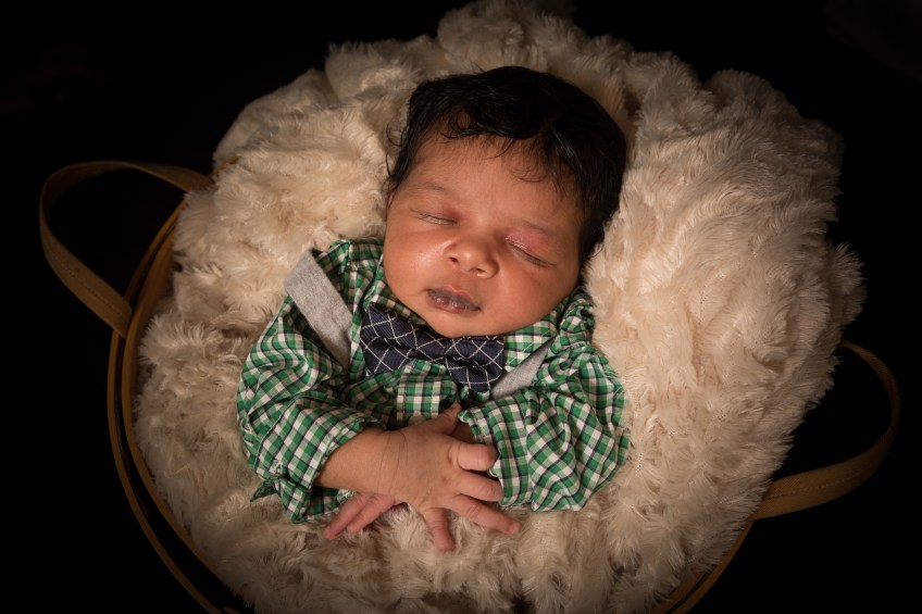 newborn boy in basket
