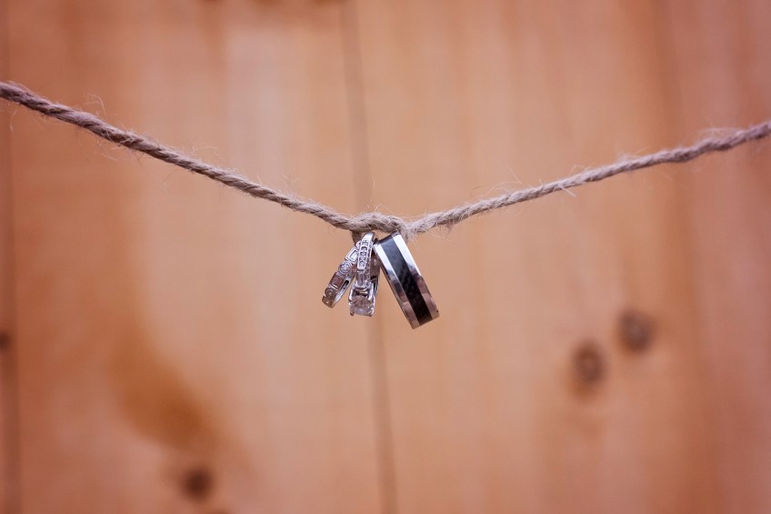 wedding rings are tied in a knot on a string