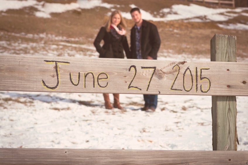engagement photo with date on wooden fence in millersville, pa