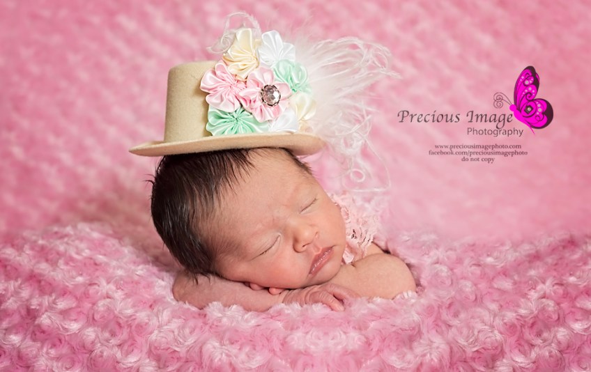 newborn girl wearing lady gaga hat