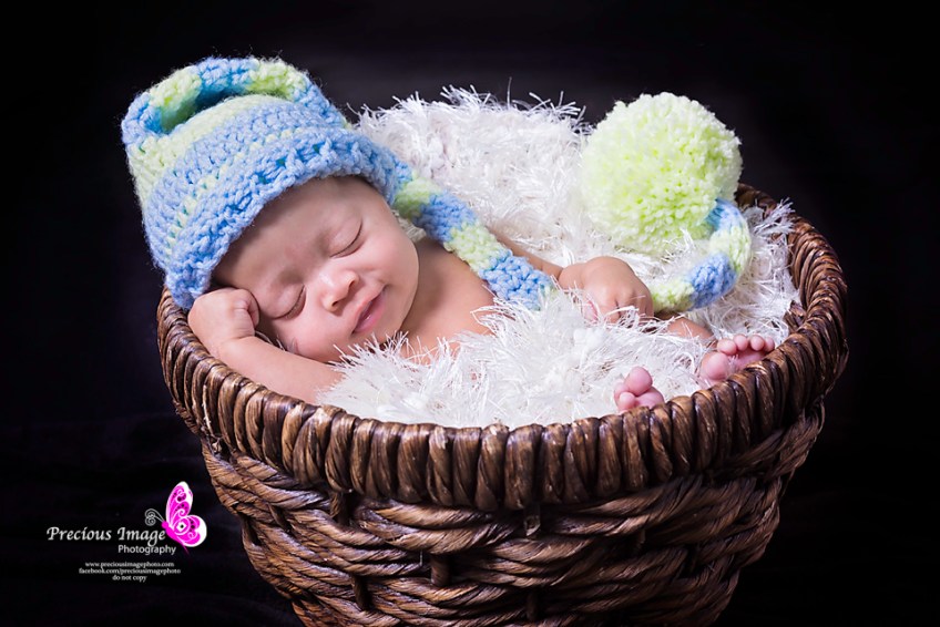 baby smiling in a basket