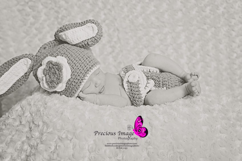 newborn girl wearing crocheted bunny outfit
