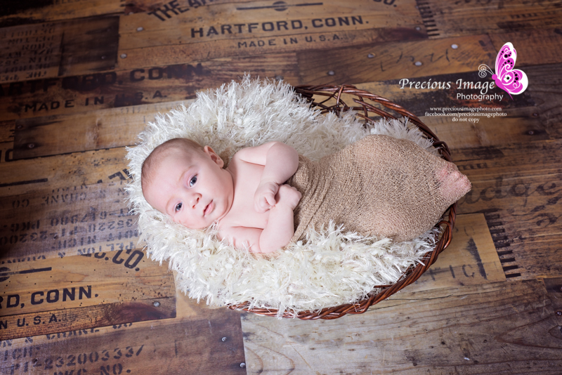 baby in basket on wood floor in quarryville, pa